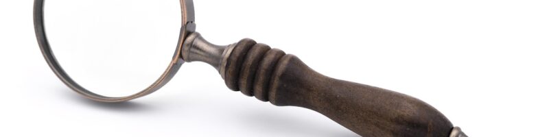 Magnifying glass focusing on digital search results, symbolizing Generative Engine Optimization (GEO) and business visibility in AI discovery tools like ChatGPT and Perplexity.