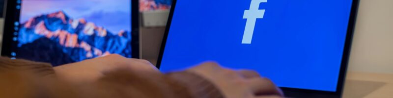 Laptop displaying facebook logo