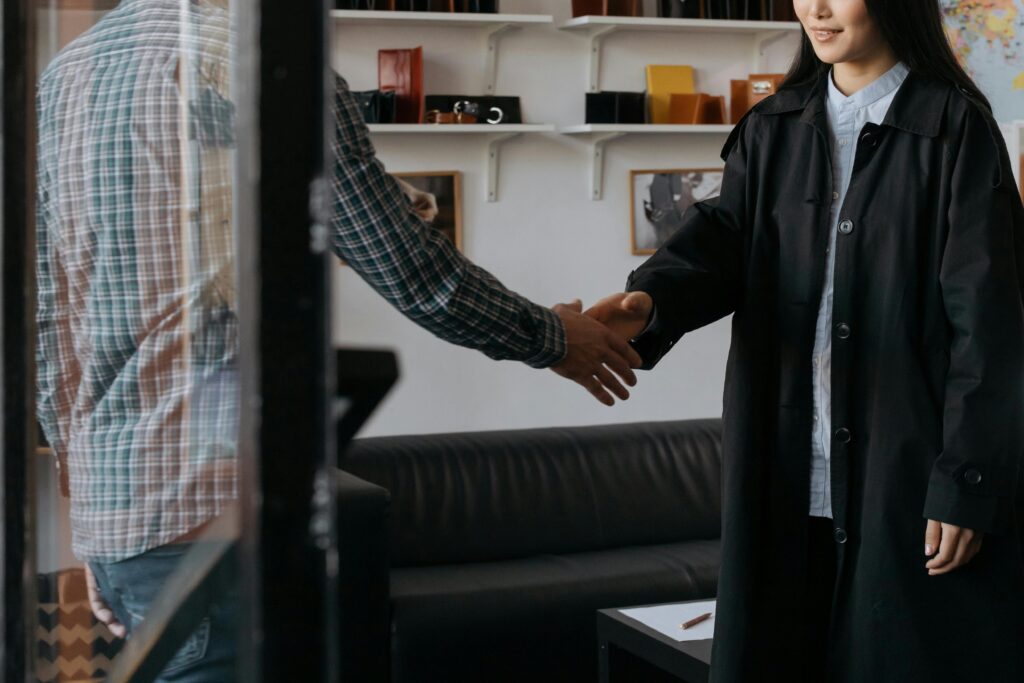 The Digital Handshake: Why Reputation Management is the Modern Small Business Currency Two professionals engage in a handshake, symbolizing a successful agreement in a contemporary office.